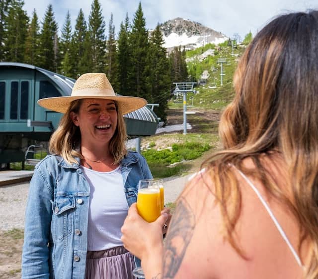 Two women enjoying brunch and mimosas in the mountains at Brighton Resort